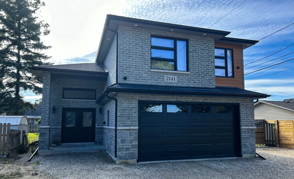 Modern two-story house with a grey brick facade in Windsor, Ontario.